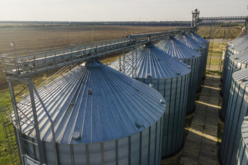 Grain storage silos. Galvanized tanks for grain. Granary with mechanical equipment. Aerial wide view © Leonid