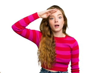 Young caucasian redhead woman isolated shouts loud, keeps eyes opened and hands tense.