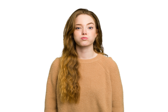 Young caucasian redhead woman isolated blows cheeks, has tired expression. Facial expression concept.