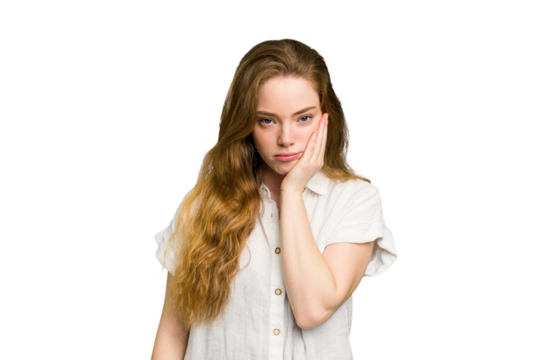 Young caucasian redhead woman isolated who feels sad and pensive, looking at copy space.