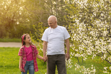 grandfather and granddaughter in backyard