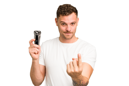 Young caucasian man holding a razor isolated pointing with finger at you as if inviting come closer.