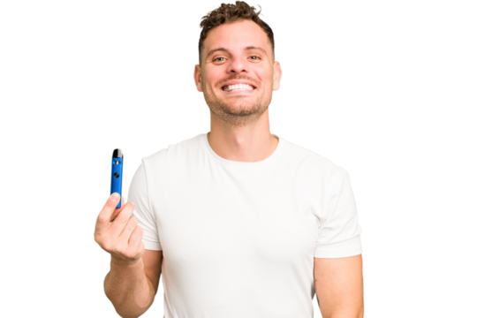 Young caucasian man holding a electronic cigarette isolated happy, smiling and cheerful.