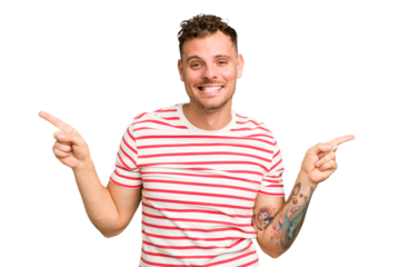 Young caucasian handsome man isolated pointing to different copy spaces, choosing one of them, showing with finger.