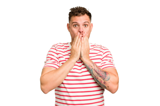 Young caucasian handsome man isolated shocked, covering mouth with hands, anxious to discover something new.