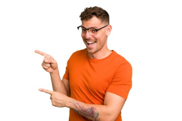 Young caucasian handsome man isolated pointing with forefingers to a copy space, expressing excitement and desire.