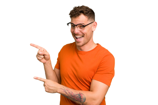 Young caucasian handsome man isolated pointing with forefingers to a copy space, expressing excitement and desire.