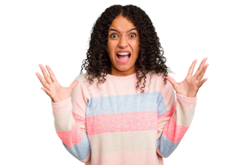 Young Brazilian curly hair cute woman isolated screaming to the sky, looking up, frustrated.