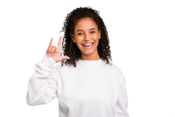 Young Brazilian curly hair cute woman isolated showing a horns gesture as a revolution concept.