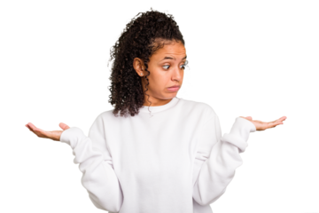 Young Brazilian curly hair cute woman isolated confused and doubtful shrugging shoulders to hold a copy space.