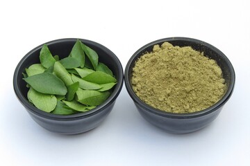 Curry leaves and powder in bowls 