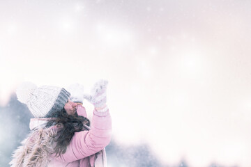 Welcome winter,happy girl, woman enjoys winter and plays with snow in the middle of a snowy landscape,in warm clothes with a hat and gloves,cold and Christmas atmosphere,photo in snowy nature,healthy