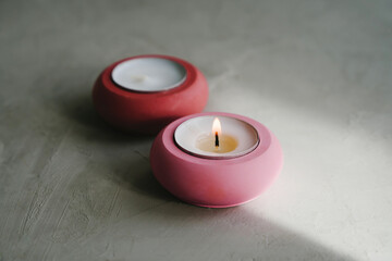 Obraz na płótnie Canvas Gypsum candlesticks in the color of the year 2023. Candles for spa, home decor. The concept of the color of the year 2023 - viva magenta, red hue 18-1750.