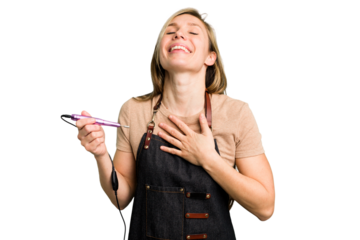 Young caucasian manicurist woman holding an electric file drill isolated laughs out loudly keeping hand on chest.