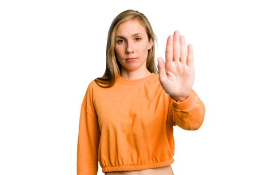 Young caucasian woman cutout isolated standing with outstretched hand showing stop sign, preventing you.