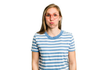 Young caucasian woman cutout isolated blows cheeks, has tired expression. Facial expression concept.