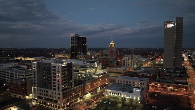Fort Wayne, Indiana skyline close up at night with drone video moving sideways.