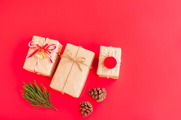 Christmas and New year decorations, Gift box, Pine cones, Pine branch, Golden bell and Red decoration on red background