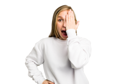 Young caucasian woman cutout isolated having fun covering half of face with palm.