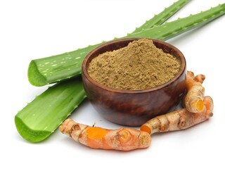 Aloe Vera powder in a bowl with turmeric root on white background 
