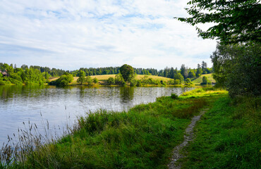 Fototapeta na wymiar Eschenbacher Teich near Clausthal-Zellerfeld in the Upper Harz Mountains. Idyllic landscape at the small lake with the surrounding nature. 