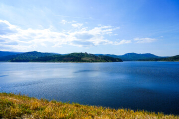 View of the Grane reservoir with the surrounding nature near Goslar. Landscape at the Granetalsperre in the Harz Mountains.
