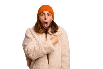 Young caucasian woman wearing winter clothes isolated pointing to the side