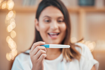 Pregnancy test, excited and face of a woman reading results, wow smile and hand with surprise in a house. Happy, pregnant and mother with a test for pregnancy, good news and happiness in a home