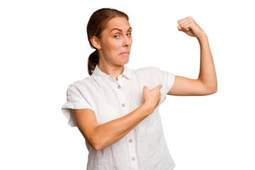 Young caucasian woman isolated showing strength gesture with arms, symbol of feminine power