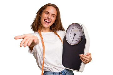 Young nutritionist caucasian woman holding scale and mesure tape isolated