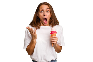 Young caucasian woman holding an ice cream isolated surprised and shocked.