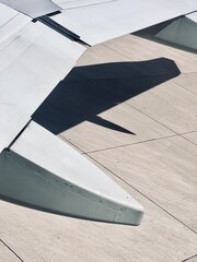 Detail view of the airplane wing waiting on the airport runway