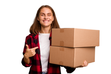 Young caucasian woman moving while picking up a box full of things isolated person pointing by hand to a shirt copy space, proud and confident