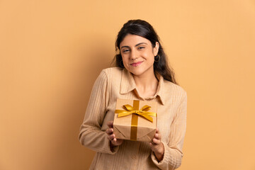 Lovely woman showing Christmas gift