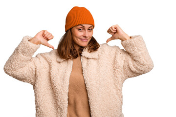 Young caucasian woman wearing winter clothes isolated feels proud and self confident, example to...