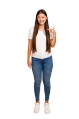 Young asian woman standing, full body cutout isolated person pointing by hand to a shirt copy space, proud and confident