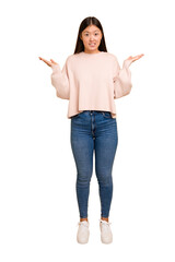 Young asian woman standing, full body cutout isolated confused and doubtful shrugging shoulders to...