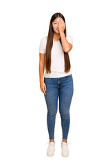 Fototapeta premium Young asian woman standing, full body cutout isolated having fun covering half of face with palm.