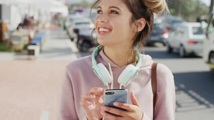 Woman, phone typing and social media in city street, urban lifestyle and outdoor on mobile app, internet and tech. Happy gen z girl, young student and cool influencer on smartphone for social network