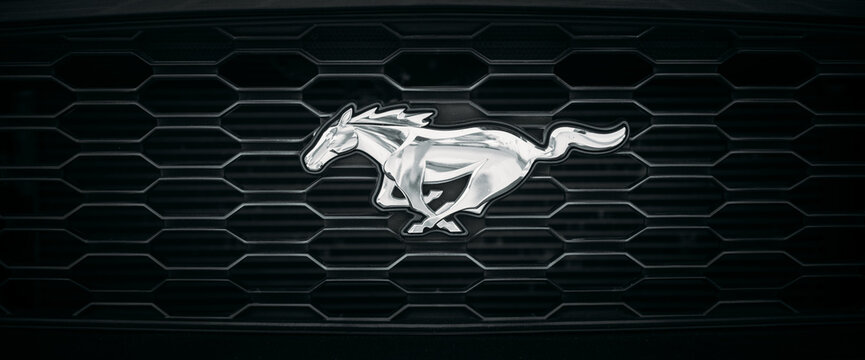 Dubai, UAE, United Arab Emirates - May 25, 2021: Close View Of Logo Logotype Sign Of Ford Mustang on hood. Ford Mustang is series of American automobiles manufactured by Ford. The namesake of the pony