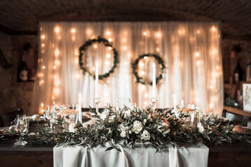 Beautiful wedding room with wedding table with food, flowers anddrinks, decorations,lights 