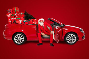 Photo of confident granddad sit automobile posing deliver present gifts wear costume isolated white...
