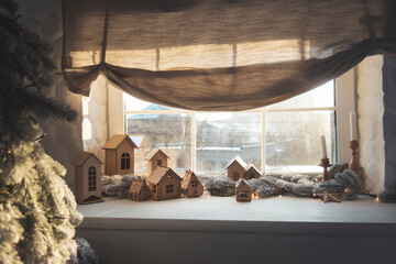 wooden decorative houses stand on the windowsill, New Year's decor