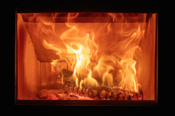 Fire flames and burning wood logs, energy stove fireplace close up,