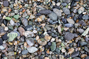 Seamless abstract background top view. Close-up texture of colorful sea pebbles. Drainage
