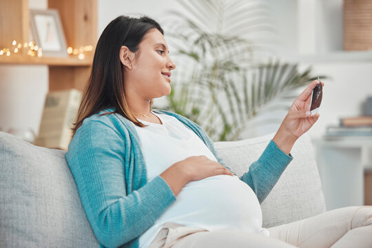 Pregnant woman, photograph and relax on sofa in living room for peace, calm or energy. New mother, baby and happy smile for child love, ultrasound and pregnancy care or mom relaxing on couch in home