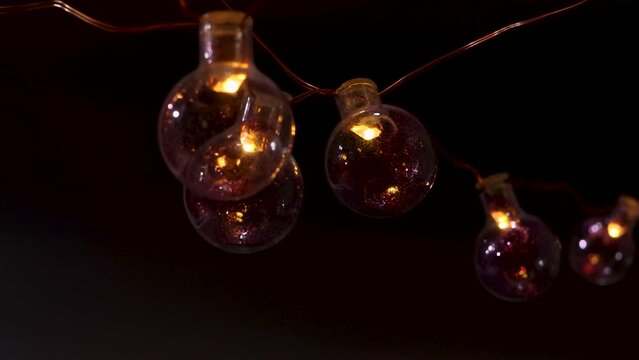Decoration for holiday. String light hanging glass bulbs at night.