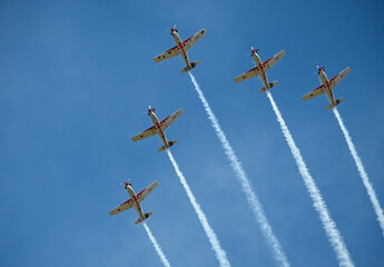 Airplanes on the blue sky during airshow. Five aero planes in formation. Air display team flying in...