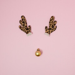 Christmas reindeer concept of red decoration on pink background. Winter holidays idea. Flat lay.