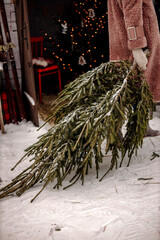 girl in a fur coat holding a spruce in her hand